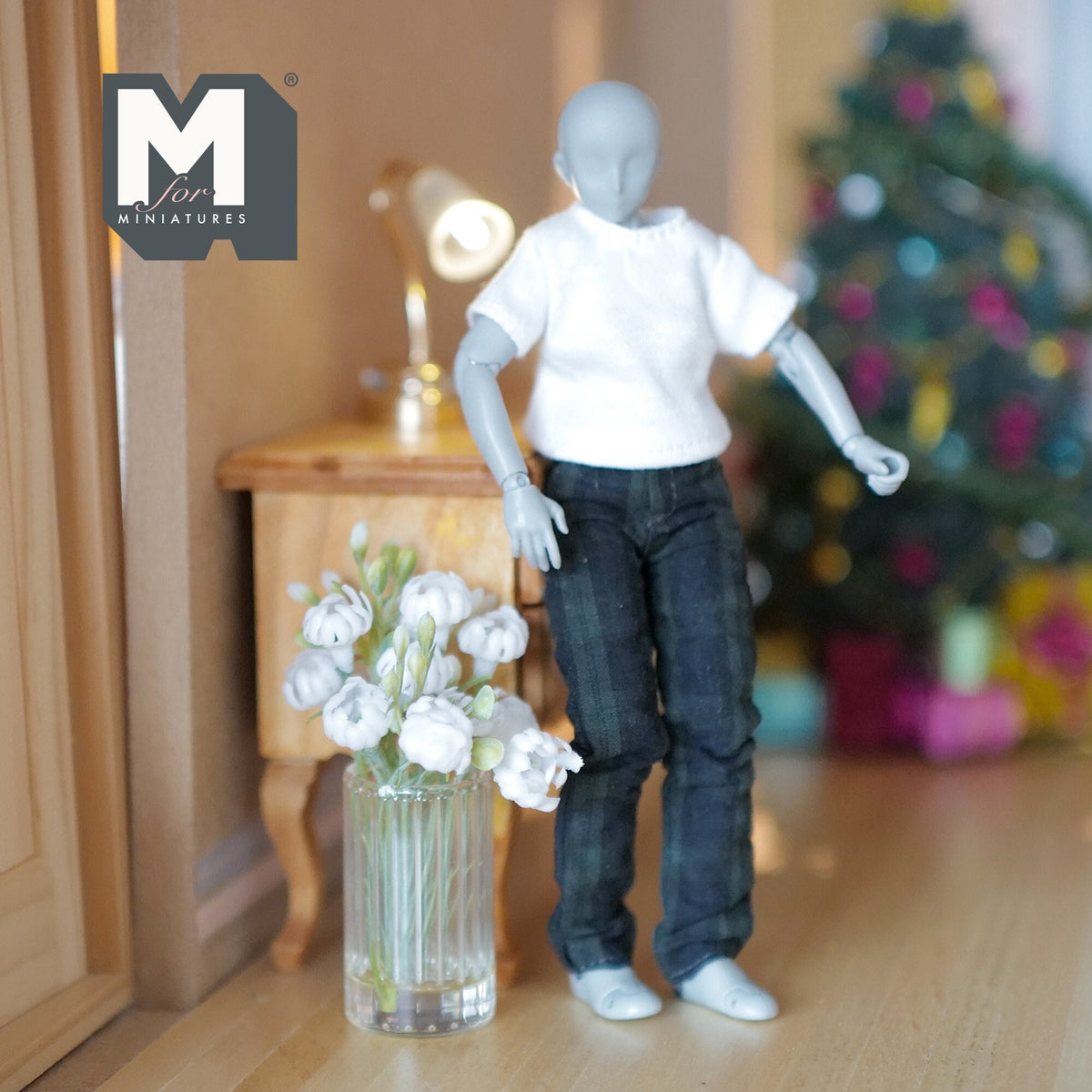 1:12 scale miniature white flower bouquet in a round clear glass vase, shown beside an artist figure