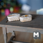 1:12 scale miniature wicker cutlery baskets in cream, oval, set of 2, shown side by side on a gray wood table