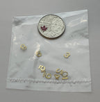 1:12 scale miniature brass house numbers 0 to 9 in gold, set of 10, loose digits shown in a clear bag beside a coin