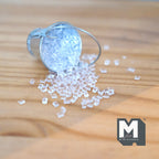 1:12 scale miniature metal tin bucket in silver with clear ice cubes, shown tipped over on a wood table