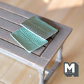 1:12 scale miniature ceramic rectangular plates in green with ridged leaf pattern, set of 2, on a gray wood table