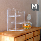 1:12 scale miniature clear acrylic corner shelf with 3 tiers and scalloped edges, shown on a wood dresser