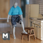 1:12 scale miniature wood kitchen step stool with 2 steps in walnut, shown with an artist figure stepping on it