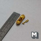 1:12 scale miniature gold door knob plate with key, ornate backplate shown beside a metal ruler on gray fabric