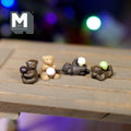1:12 scale miniature chocolate bear cubs with balls, set of 4 in dark and light brown, shown on a wood table