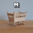 1:12 scale miniature unpainted wood rocking baby cradle with slatted sides and scalloped rails, on a wood floor