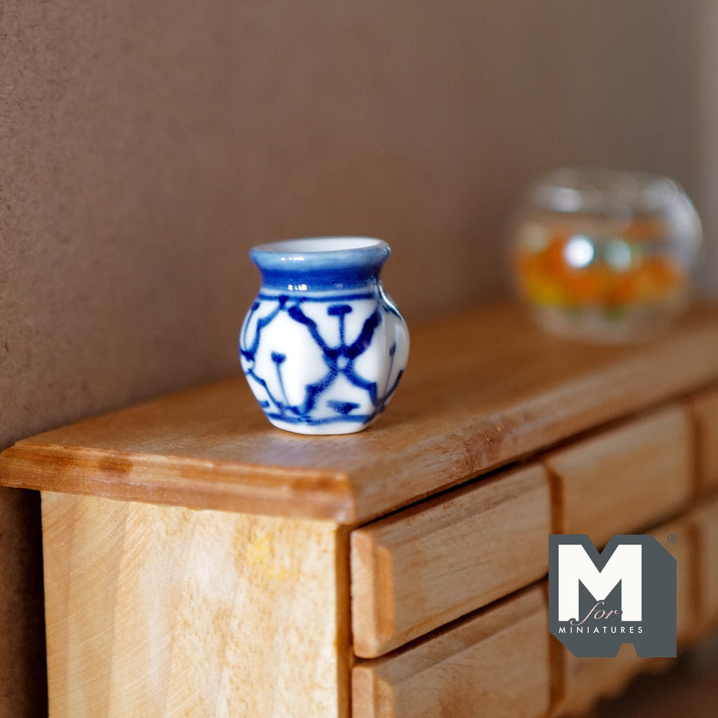 1:12 scale miniature ceramic hexagon vase with blue and white pattern, shown on a wood dresser