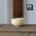 1:12 scale miniature large bowls in cream, set of 2, shown stacked on a dark wood table