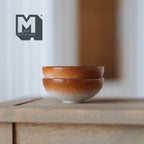 1:12 scale miniature large bowls in brown and cream glaze, set of 2, shown stacked on a wood table