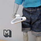 1:12 scale miniature white metal clothes hangers, set of 6, shown held by a poseable figure