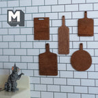 1:12 scale miniature wood cutting boards, set of 5 in assorted shapes, dark brown, shown on a white tile wall