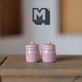 1:12 scale miniature pink ceramic jars with lids, set of 2, glossy canisters shown on a wood surface