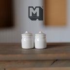 1:12 scale miniature ceramic jars with lids in glossy white, set of 2, shown on a wood table