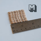 1:12 scale miniature unpainted wood bobbin handrail spindles, set of 12, laid in a row beside a ruler