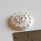1:12 scale miniature Victorian style ceiling rose with flower center, round white medallion, shown with a ruler for scale