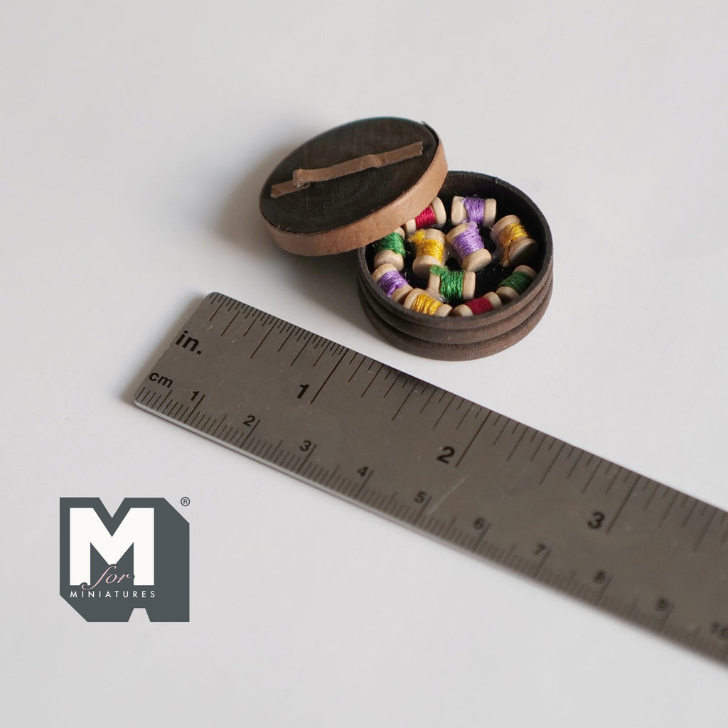 1:12 scale miniature wood sewing box with lid and colorful thread spools, round box shown open beside a ruler