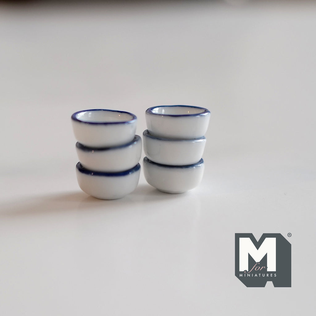 1:12 scale miniature white ceramic bowls with blue rim, set of 6, shown in two stacks of three on a white surface
