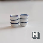 1:12 scale miniature white ceramic bowls with blue rim, set of 6, shown in two stacks of three on a white surface