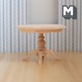 1:12 scale miniature unpainted wood octagon pedestal table with a turned column and four feet, on a wood floor