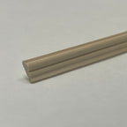 Miniature wainscot wood rail for walls, unfinished light wood, close-up showing the rounded and grooved profile end