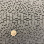 1:12 scale fan pattern cobblestone paving foam board in gray with embossed stones, shown with a coin for scale