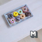 1:12 scale miniature glazed donuts with metal tray, set of 9, assorted icing colors with sprinkles, shown on a table