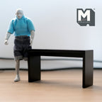 1:12 scale miniature modern console table in black with a slim straight frame, shown beside an artist figure