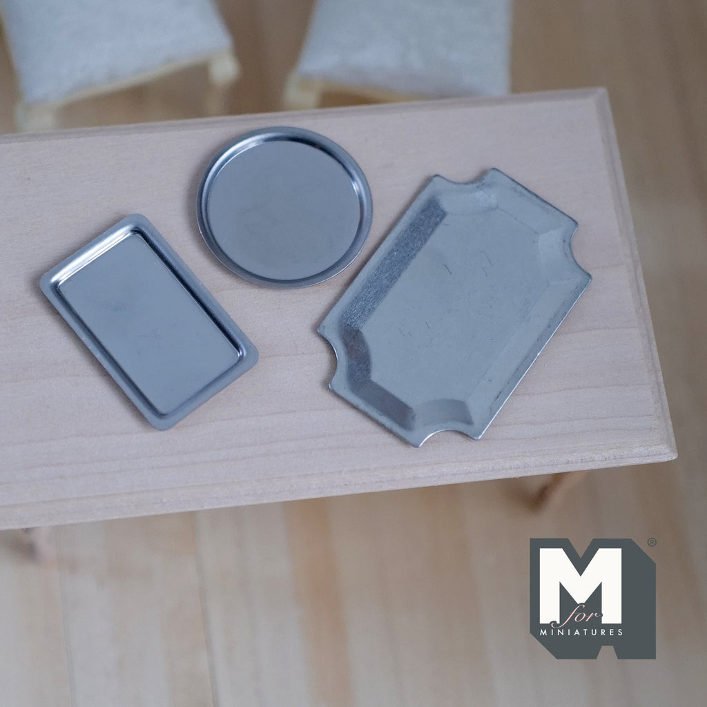 1:12 scale miniature aluminum serving trays, set of 3, rectangular and round, silver finish, shown on a wood table