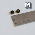 1:12 scale miniature antique brass ring drawer pulls with round backplates, set of 2, shown with a ruler