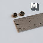 1:12 scale miniature antique brass ring drawer pulls with round backplates, set of 2, shown with a ruler