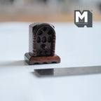 1:12 scale miniature cathedral tabletop radio in brown with arched top, shown beside a ruler for scale