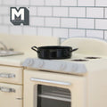 1:12 scale miniature metal cooking pot in black with 2 side handles, shown on a cream stove in a tiled kitchen