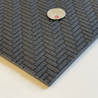 1:12 scale large herringbone brick paving foam board in dark gray with embossed texture, shown with a coin