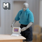 1:12 scale miniature metal CRT desktop computer in white with keyboard, non working, held by an artist figure