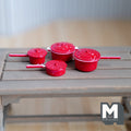 1:12 scale miniature red metal cooking pots in speckled enamel style, set of 4 with lids and handles, on a gray table