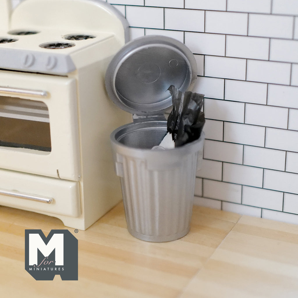 1:12 scale miniature trash bin in gray with lid and trash inside, shown in a kitchen beside a cream stove