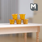 1:12 scale miniature gold ice cream cups with lids, set of 5, shown stacked on a wood table