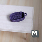 1:12 scale miniature oval rope basket with handles in purple, woven texture, shown empty on a wood table