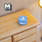 1:12 scale miniature cast resin round decoration pot in pale blue with white raised relief figures, on a wood dresser