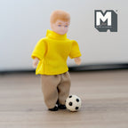 1:12 scale miniature kid size soccer ball in black and white, shown at the feet of a boy figure in a yellow shirt