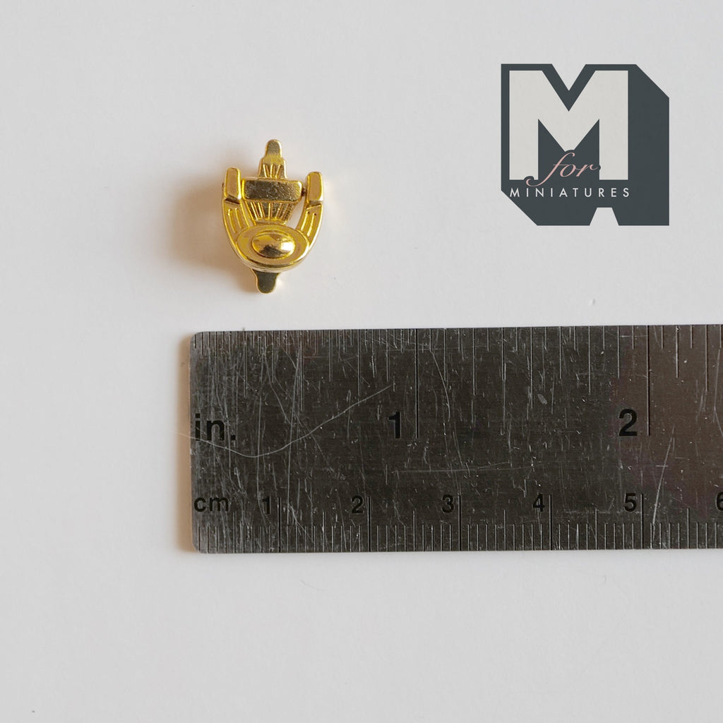 1:12 scale miniature horseshoe door knocker in gold with decorative top, shown above a ruler for scale
