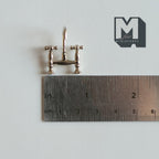 1:12 scale miniature bridge mixer tap with cross handles, silver metal faucet shown above a ruler for scale