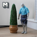 1:12 scale miniature cone topiary in round pot, green foliage in a brown pot, shown beside a jointed figure for scale