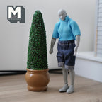 1:12 scale miniature cone topiary in round pot, green foliage in a brown pot, shown beside a jointed figure for scale