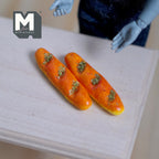 1:12 scale miniature seeded baguettes with golden crust, set of 2, shown on a bare wood table