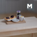1:12 scale miniature breakfast board with jam toast, jam jar and lemon tea on a wood board, shown on a wood table