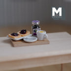 1:12 scale miniature breakfast board with jam toast, jam jar and lemon tea on a wood board, shown on a wood table
