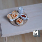1:12 scale miniature breakfast board with toast, a glass of milk and a jug of jam, shown on a white wood table