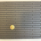1:12 scale miniature wood plank style flooring foam board in dark gray with embossed planks, shown with a coin for scale