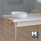 1:12 scale miniature large dinner plates in white, set of 2, shown stacked on a bare wood table